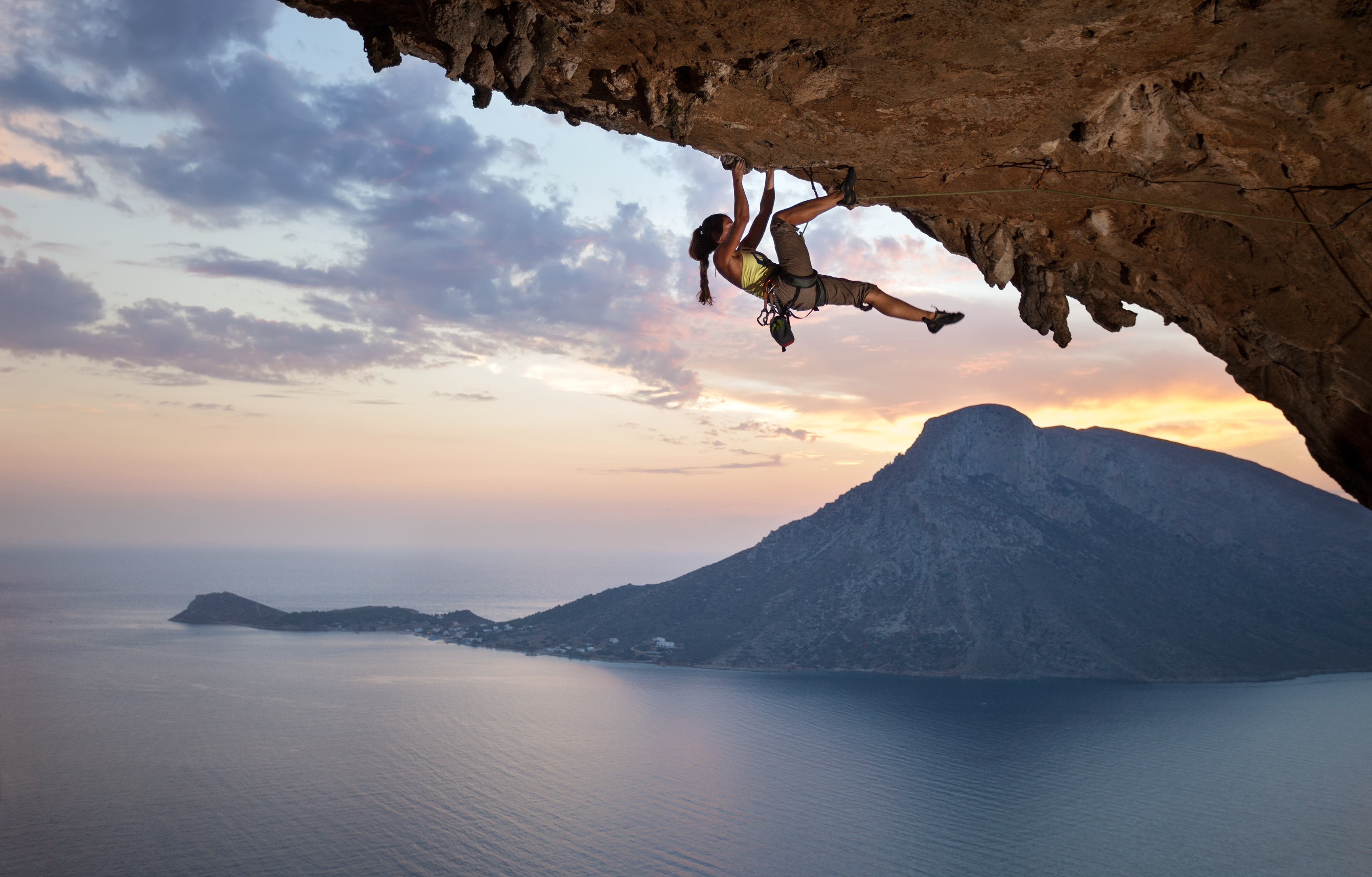 Climber on outdoor rock route in climbing shoes