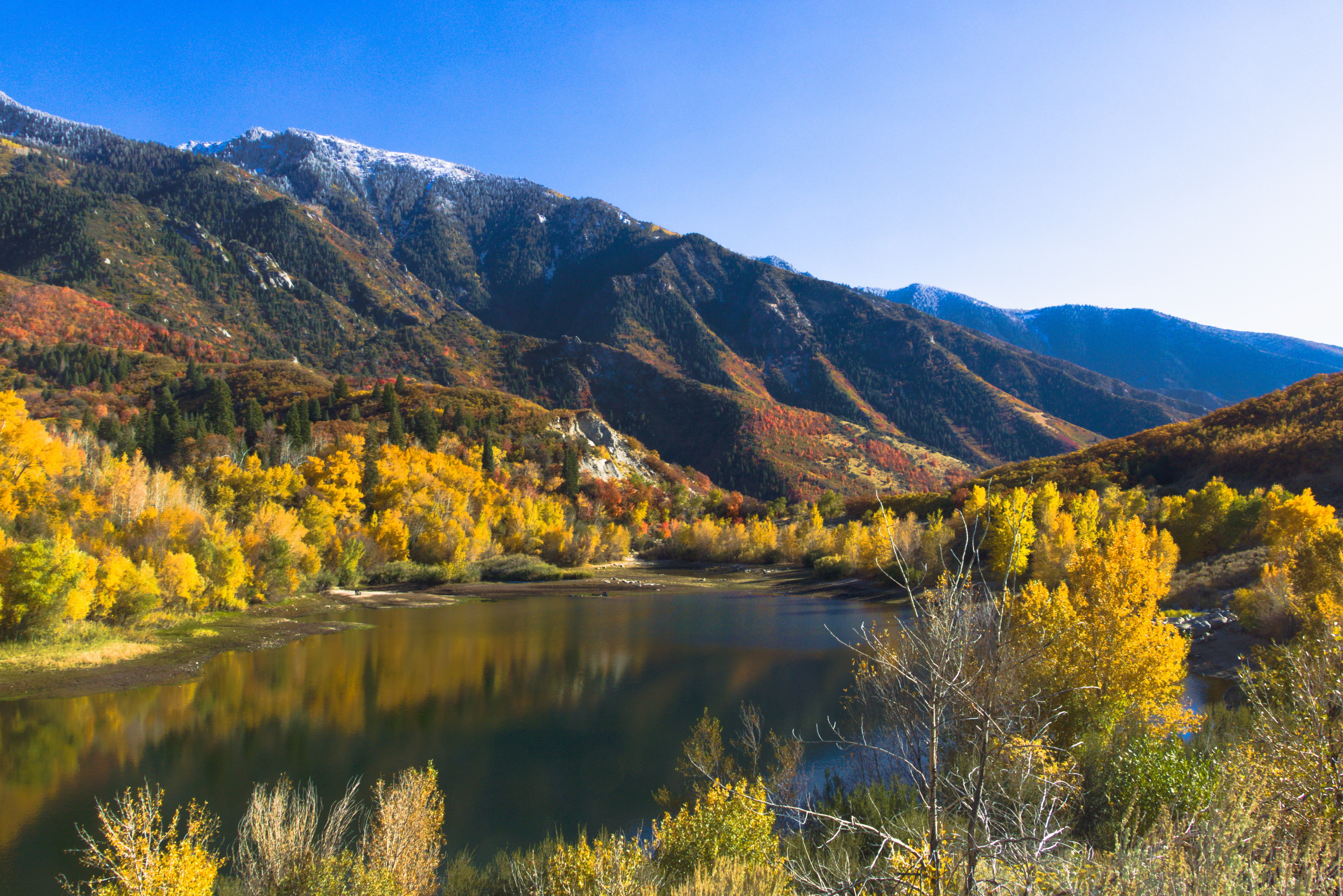 Bell Canyon Trail lower reservoir with spring snowmelt and Wasatch ridgeline