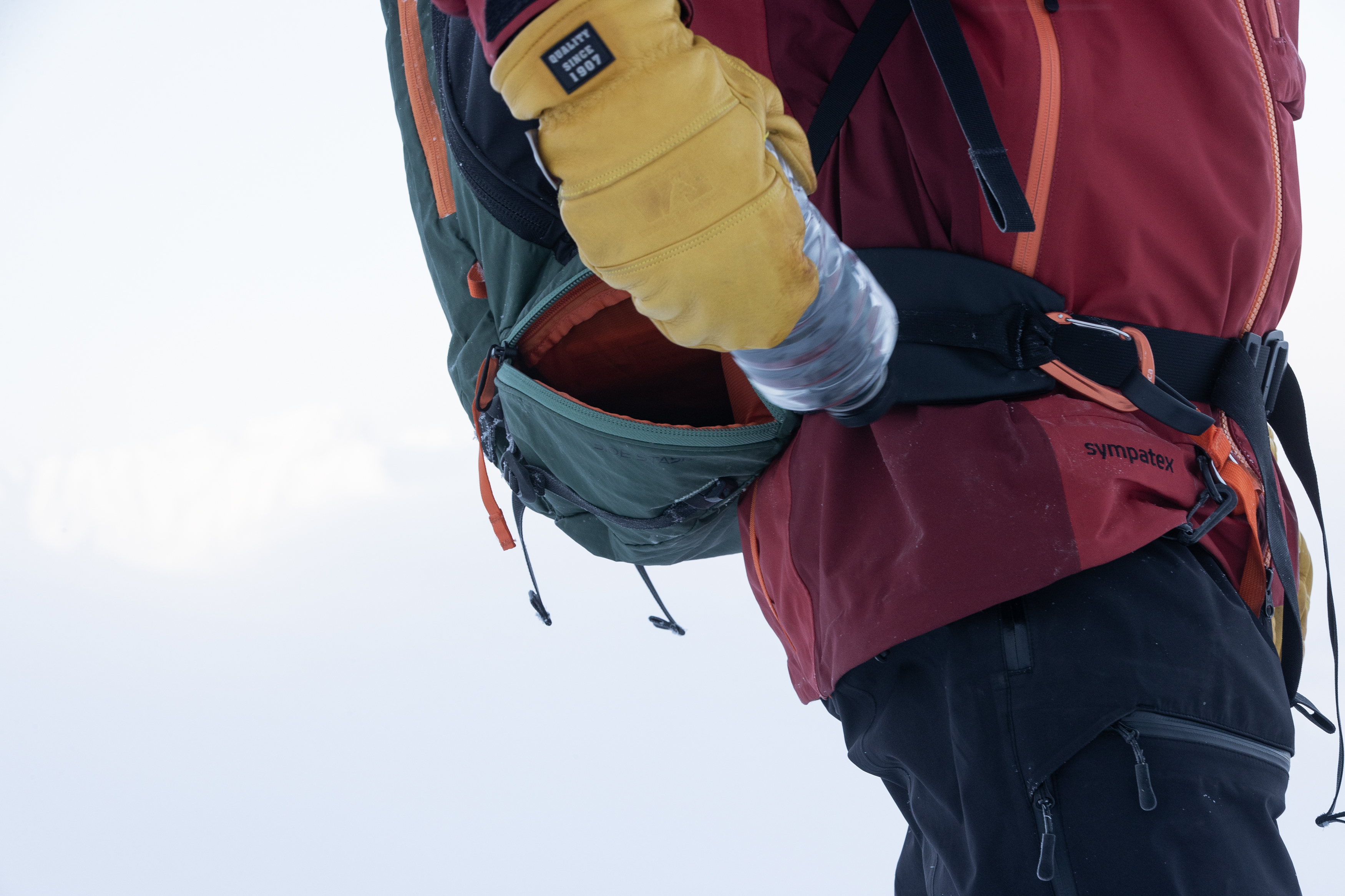 Float E2-35 Feature Detail Curved side access zipper and stash pockets on the Backcountry Access Float E2-35 Avalanche Airbag Backpack