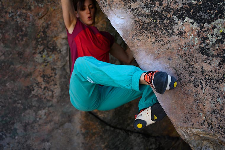 Climber on a boulder wearing the La Sportiva Women's Solution Climbing Shoe