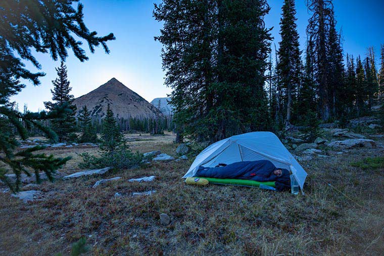 Camper sleeping on their side in a Big Agnes tent