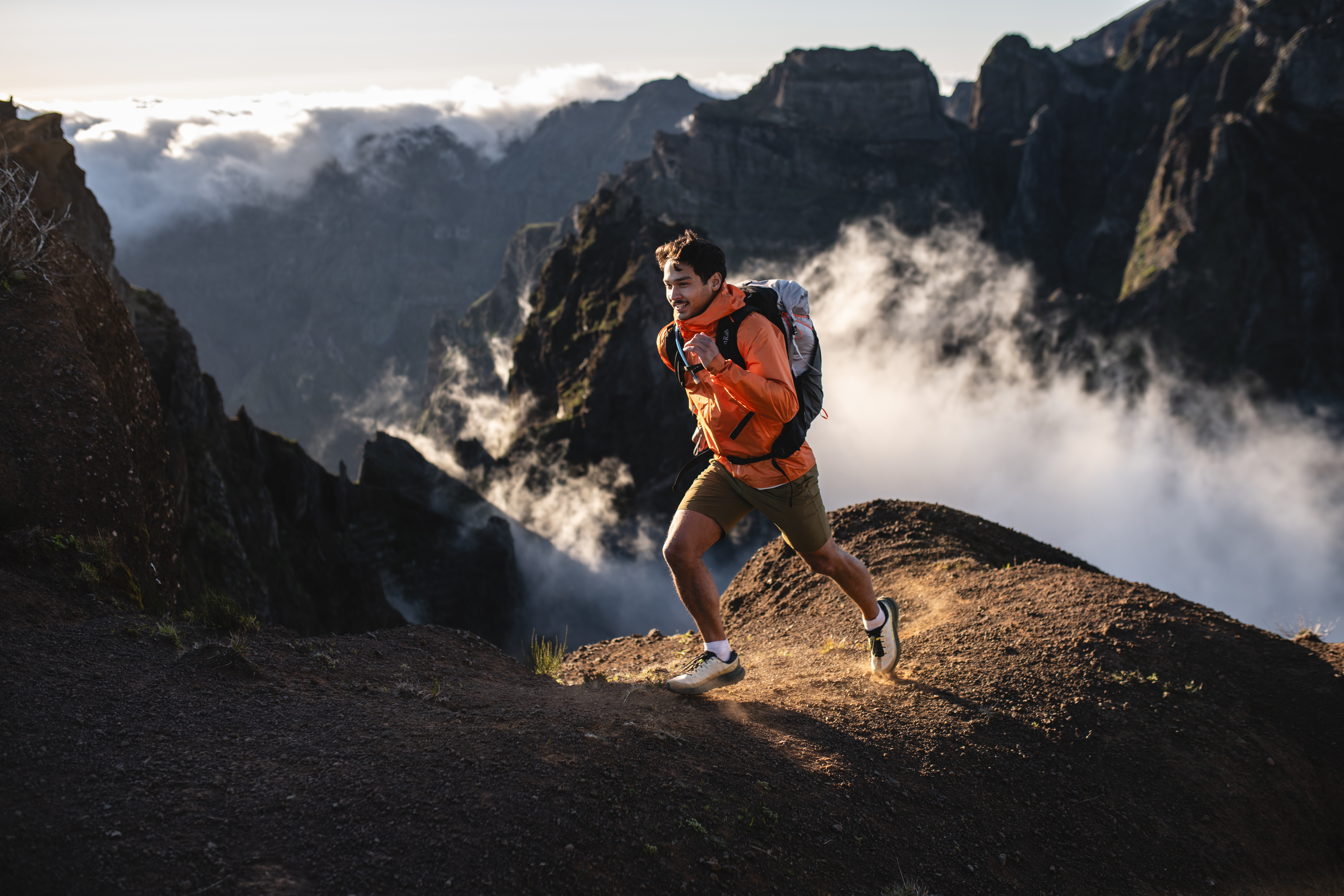 Hiker wearing the Rab Kinetic 2.0 waterproof softshell jacket